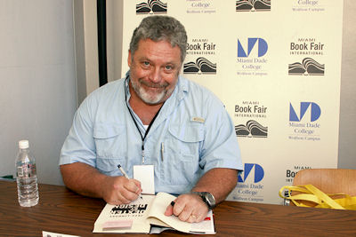 Jeff Lindsay signs a copy of his novel; Image: Property of Palley Promotes, Miami Book Fair International 2009 (used by permission)